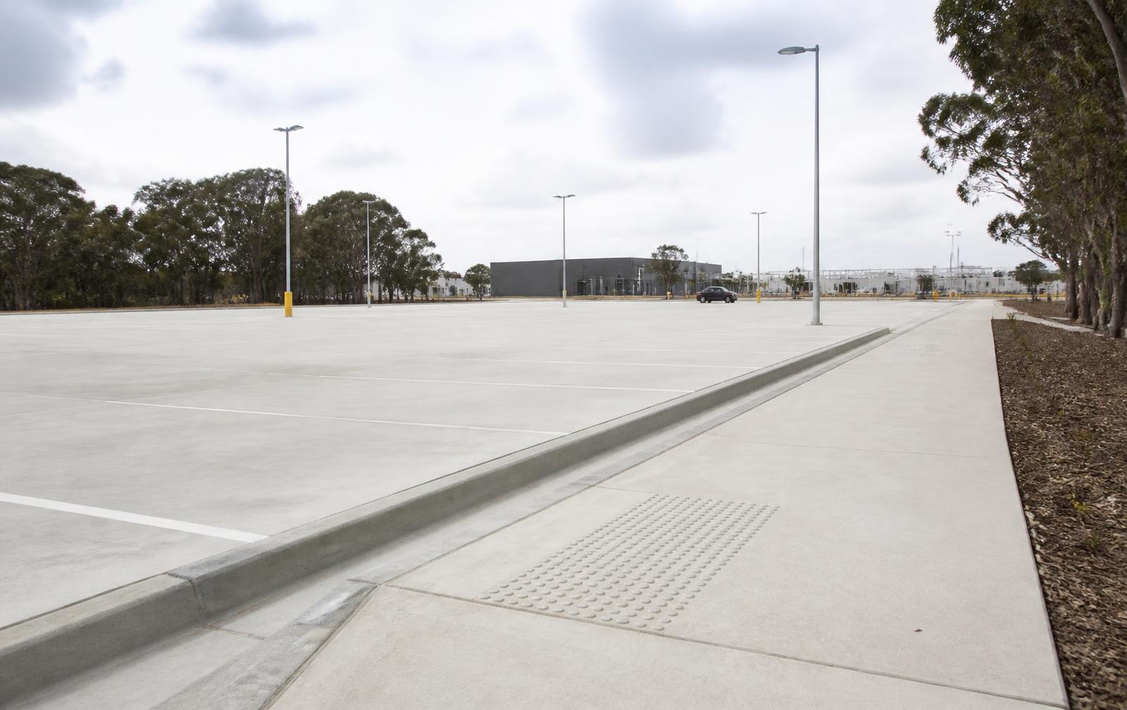 New concrete car park with kerb and channel and a concrete footpath